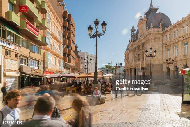 crowd people tourists walking at consistorial palace, cartagena, murcia,city hall of cartagena in spain - salamanca stock pictures, royalty-free photos & images