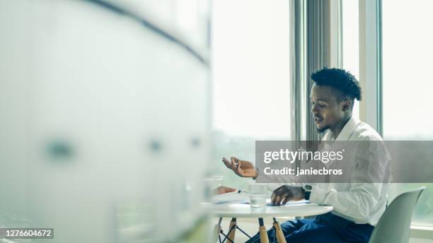 board room. african businessman on a meeting. looking through open door - turnover sport imagens e fotografias de stock