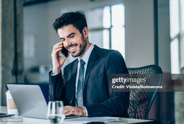 businessman in office talking on phone. - bankers stock pictures, royalty-free photos & images