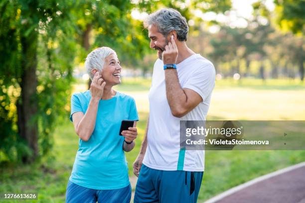 sporty couple jogging - 50 59 years stock pictures, royalty-free photos & images