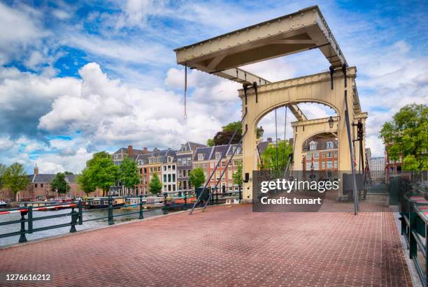 old skinny bridge (magere brug) in amsterdam - amsterdam bridge stock pictures, royalty-free photos & images