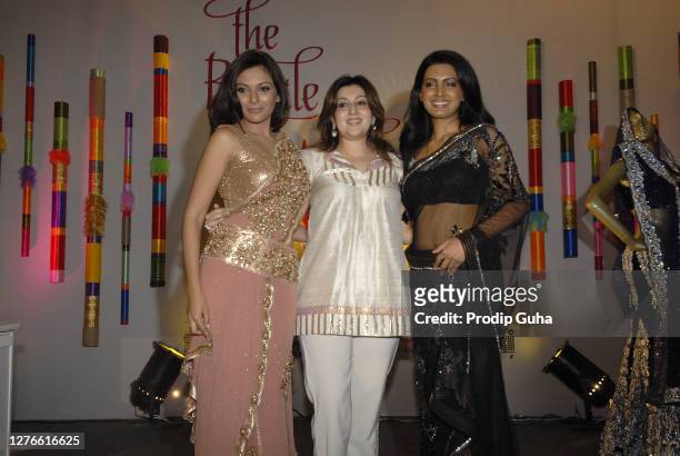 Mrinalini Sharma and Geeta Basra displays a creation by Designer Archana Kochhar at The Royale Wedding Show on July 18, 2010 in Mumbai, India
