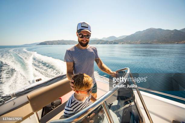 father and son yachting - sail stock pictures, royalty-free photos & images