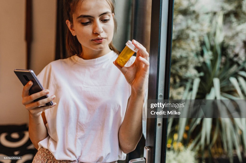Young woman searching online about medicine