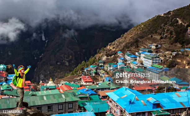 hiker appreciates the view of namche bazaar village in nepal. - mt everest base camp stock pictures, royalty-free photos & images