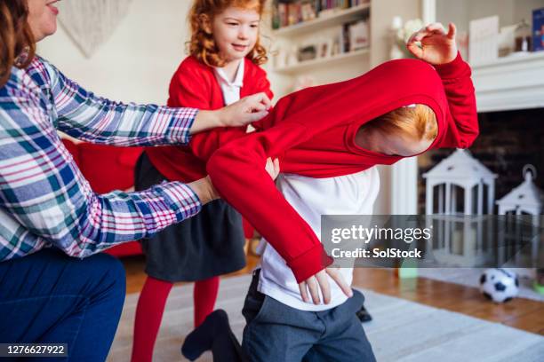 put your jumper on - family with two children british stock pictures, royalty-free photos & images