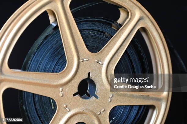 movie film reel on a black background - spool stock pictures, royalty-free photos & images