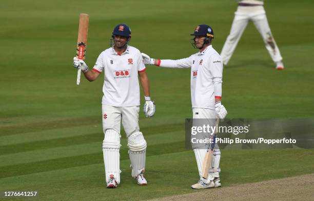 Sir Alastair Cook of Essex celebrates reaching his century with Tom Westley of Essex during the third day of the Bob Willis Trophy Final between...