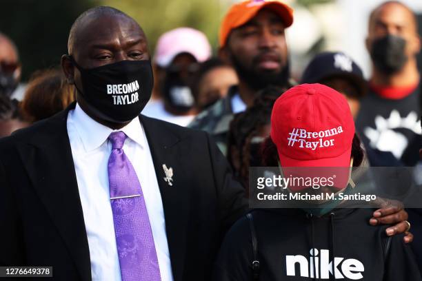 National civil rights and personal injury attorney Ben Crump places his hands on the shoulders of Ju'Niyah Palmer, Breonna Taylor's sister, as they...