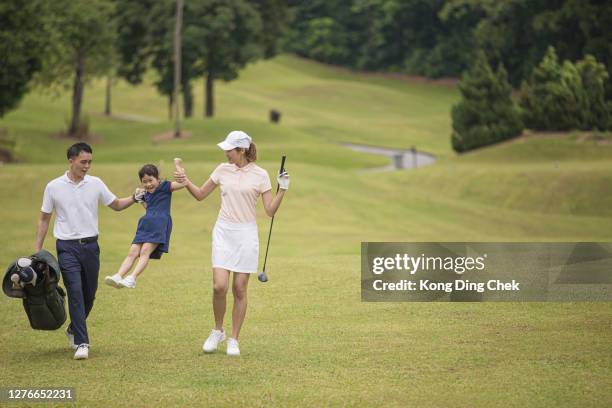 asian chinese family golfer having fun and bonding with daughter on the golf course - top golf stock pictures, royalty-free photos & images