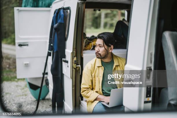 man working on his laptop in mini van - van front view stock pictures, royalty-free photos & images