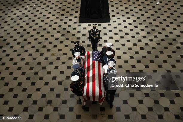 Military carry team moves U.S. Supreme Court Associate Justice Ruth Bader Ginsburg's flag-draped casket out of Statuary Hall after she layed in state...