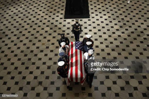 Military carry team moves U.S. Supreme Court Associate Justice Ruth Bader Ginsburg's flag-draped casket out of Statuary Hall after she layed in state...