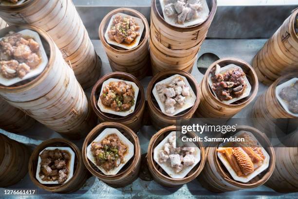 variety of chinese dimsum in bamboo steamers - dim sum stock-fotos und bilder