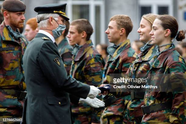 King Philippe of Belgium hands over the Blue Beret to his daughter Princess Elisabeth of Belgium and her platoon during the Blue Beret Parade at the...