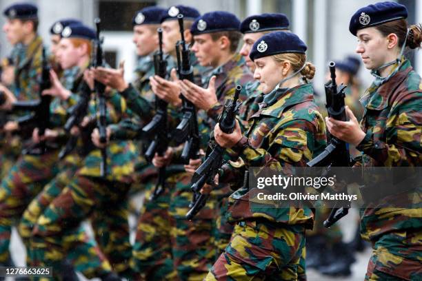 Princess Elisabeth of Belgium and her platoon salute and present arms in formation during the Blue Beret Parade at the Royal Military Academy on...