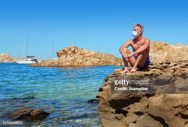 bather with a mask enjoys a day at the beach on the island of menorca - altitude sickness stock pictures, royalty-free photos & images