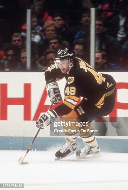 Joe Juneau of the Boston Bruins skates against the New Jersey Devils during an NHL Hockey game circa 1993 at the Brendan Byrne Arena in East...
