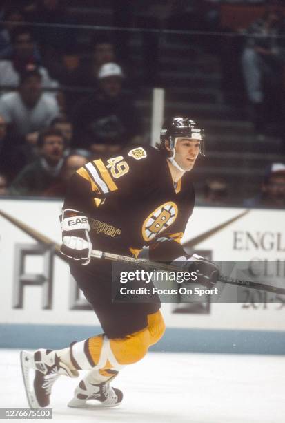 Joe Juneau of the Boston Bruins skates against the New Jersey Devils during an NHL Hockey game circa 1993 at the Brendan Byrne Arena in East...