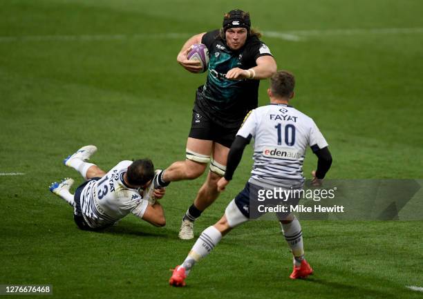 Ed Holmes of Bristol Bears is tackled by Jean-Baptiste Dubié of Bordeaux-Begles during the European Rugby Challenge Cup Semi Final match between...