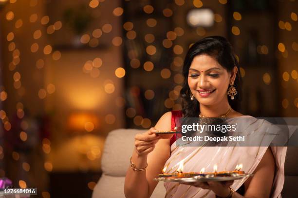 young woman diwali celebrate - stock photo - diya oil lamp stock pictures, royalty-free photos & images