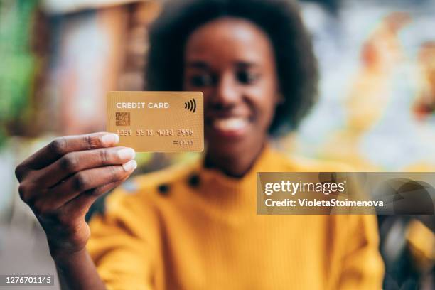 woman holding a credit card - hand holding credit card stock pictures, royalty-free photos & images