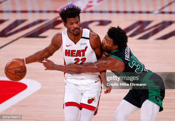 Jimmy Butler of the Miami Heat drives the ball against Marcus Smart of the Boston Celtics during the first quarter in Game Five of the Eastern...