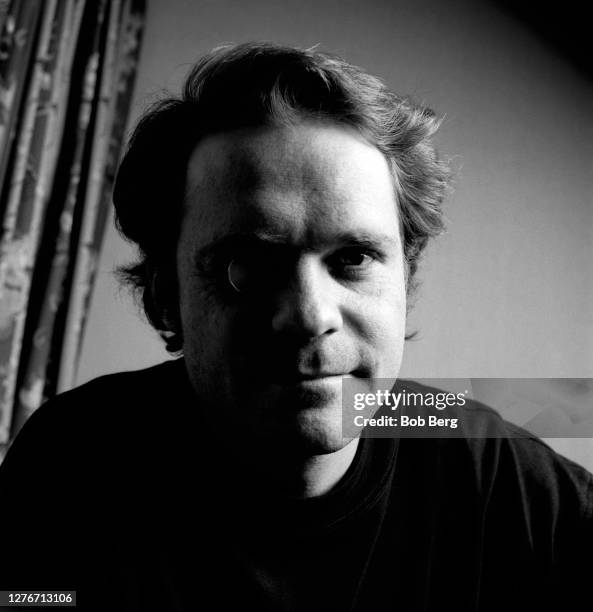 Lead singer Gordon Downie of the Canadian rock group The Tragically Hip poses for a portrait with a Canadian silver dollar covering his eye circa...