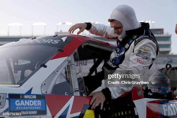 Conor Daly, driver of the iRacing Chevrolet, enters his truck to start the NASCAR Gander RV & Outdoors Truck Series World of Westgate 200 at Las...