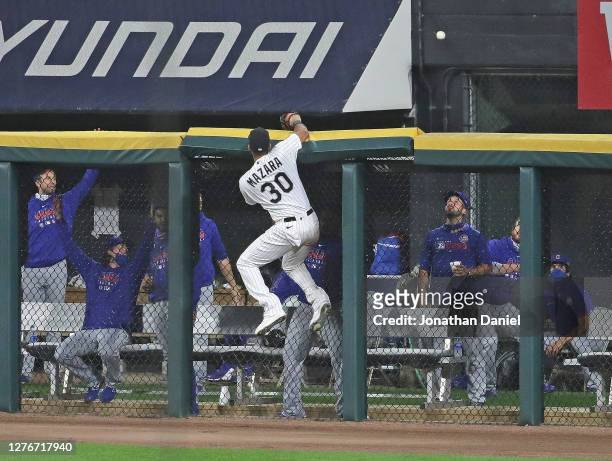 Members of the Chicago Cubs bull pen watch as a home run ball hit by Victor Caratini sails over the fence while Nomar Mazara of the Chicago White Sox...