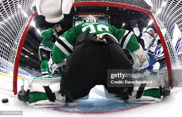 Goaltender Anton Khudobin of the Dallas Stars can't make the save on a batted puck out of the air for a goal by Brayden Point of the Tampa Bay...