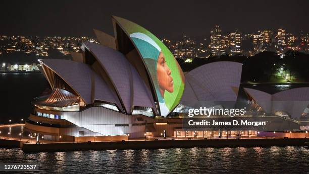 Moving video images of Cathy Freeman projected onto the sails of the Sydney Opera House on September 25, 2020 in Sydney, Australia. The projection...