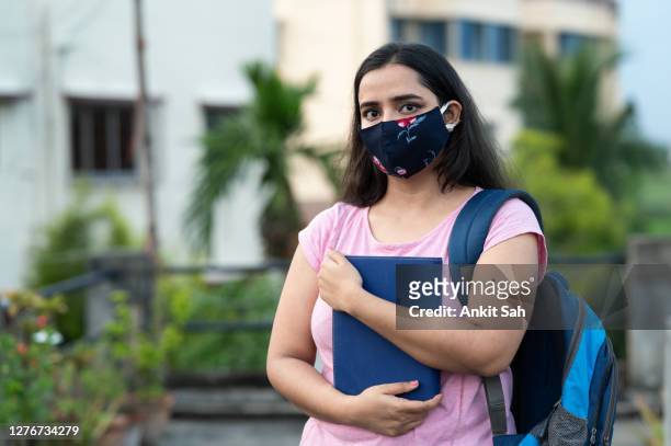 college or university student wearing protective face mask in a campus - beautiful college girls stock pictures, royalty-free photos & images