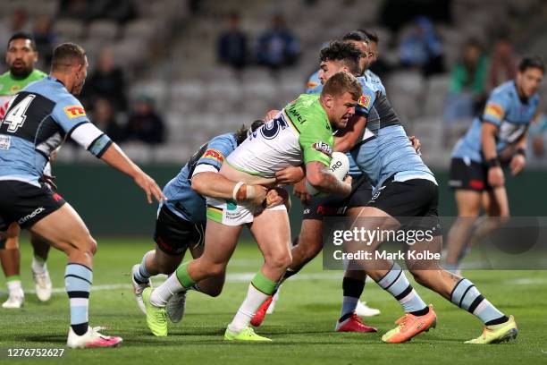 Ryan Sutton of the Raiders is tackled during the round 20 NRL match between the Cronulla Sharks and the Canberra Raiders at Netstrata Jubilee Stadium...