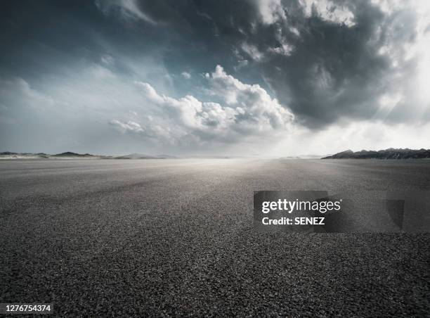 empty parking lot - dramatic sky road stock pictures, royalty-free photos & images