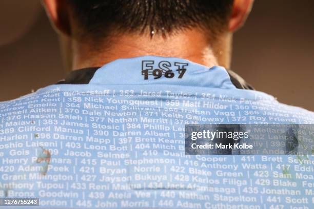 Former Sharks players names are seen on the back of a players jersey during the round 20 NRL match between the Cronulla Sharks and the Canberra...