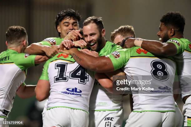 Kai O'Donnell of the Raiders celebrates with team mates after scoring a try during the round 20 NRL match between the Cronulla Sharks and the...
