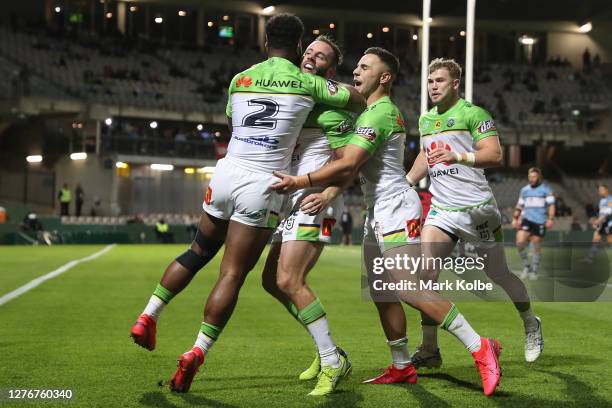 Matt Frawley of the Raiders celebrates with team mates after scoring a try during the round 20 NRL match between the Cronulla Sharks and the Canberra...