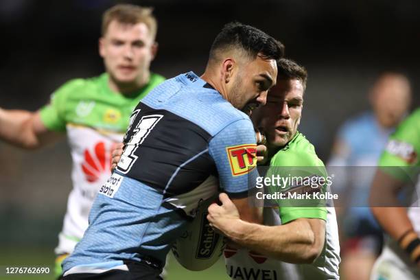 Briton Nikora of the Sharks is tackled during the round 20 NRL match between the Cronulla Sharks and the Canberra Raiders at Netstrata Jubilee...