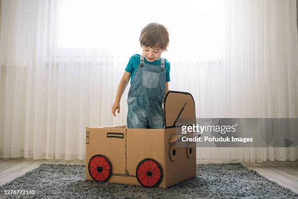 little boy play in the cardboard car - kid playing car imagens e fotografias de stock