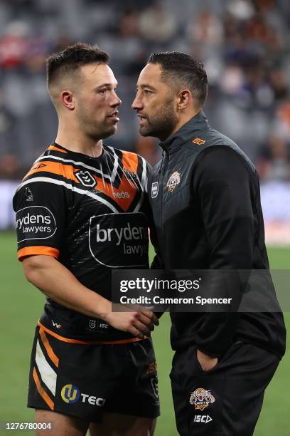 Benji Marshall of the Tigers talks with Luke Brooks of the Tigers after playing his last game for the Tigers following the round 20 NRL match between...