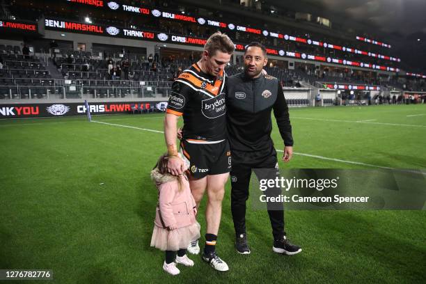 Benji Marshall of the Tigers and Chris Lawrence of the Tigers thank fans after playing their last game for the Tigers following the round 20 NRL...