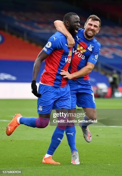 Cheikhou Kouyate of Crystal Palace celebrates with teammate James McArthur after scoring his team's first goal during the Premier League match...