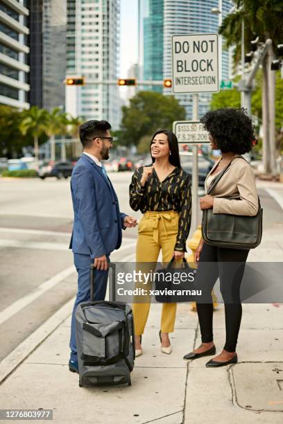 diverse businesspeople talking outdoors in downtown miami - miami business imagens e fotografias de stock