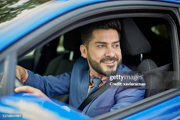 portrait of hispanic businessman in mid 30s driving car - s thirtysomething stock pictures, royalty-free photos & images
