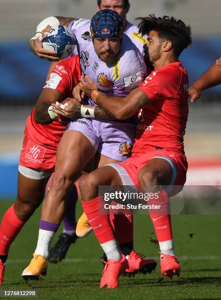 Toulouse fly half Romain Ntamack attempts to halt the run of Exeter wing Jack Nowell during the Heineken Champions Cup Semi Final match between...