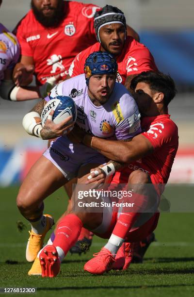 Toulouse fly half Romain Ntamack attempts to halt the run of Exeter wing Jack Nowell during the Heineken Champions Cup Semi Final match between...