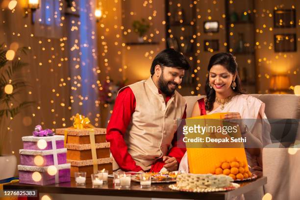 couple diwali celebrate - stock photo - diwali sweets stock pictures, royalty-free photos & images