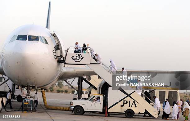 Pakistani Muslims board a Pakistan International Airlines aircraft to Mecca in Saudi Arabia, for the annual Hajj pilgrimage from Quetta International...