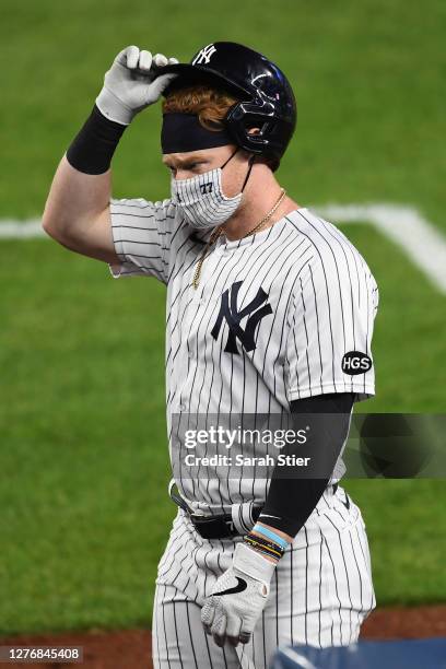 Clint Frazier of the New York Yankees takes off his batting helmet during the fifth inning against the Miami Marlins at Yankee Stadium on September...